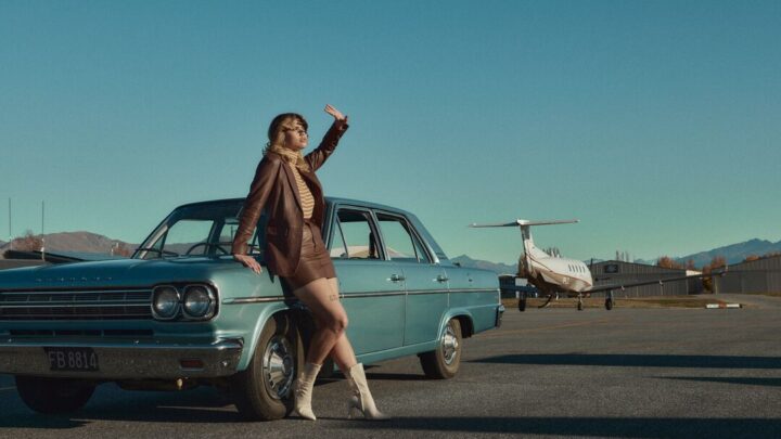 On set of Way South with girl leaning on car at Wanaka Airport